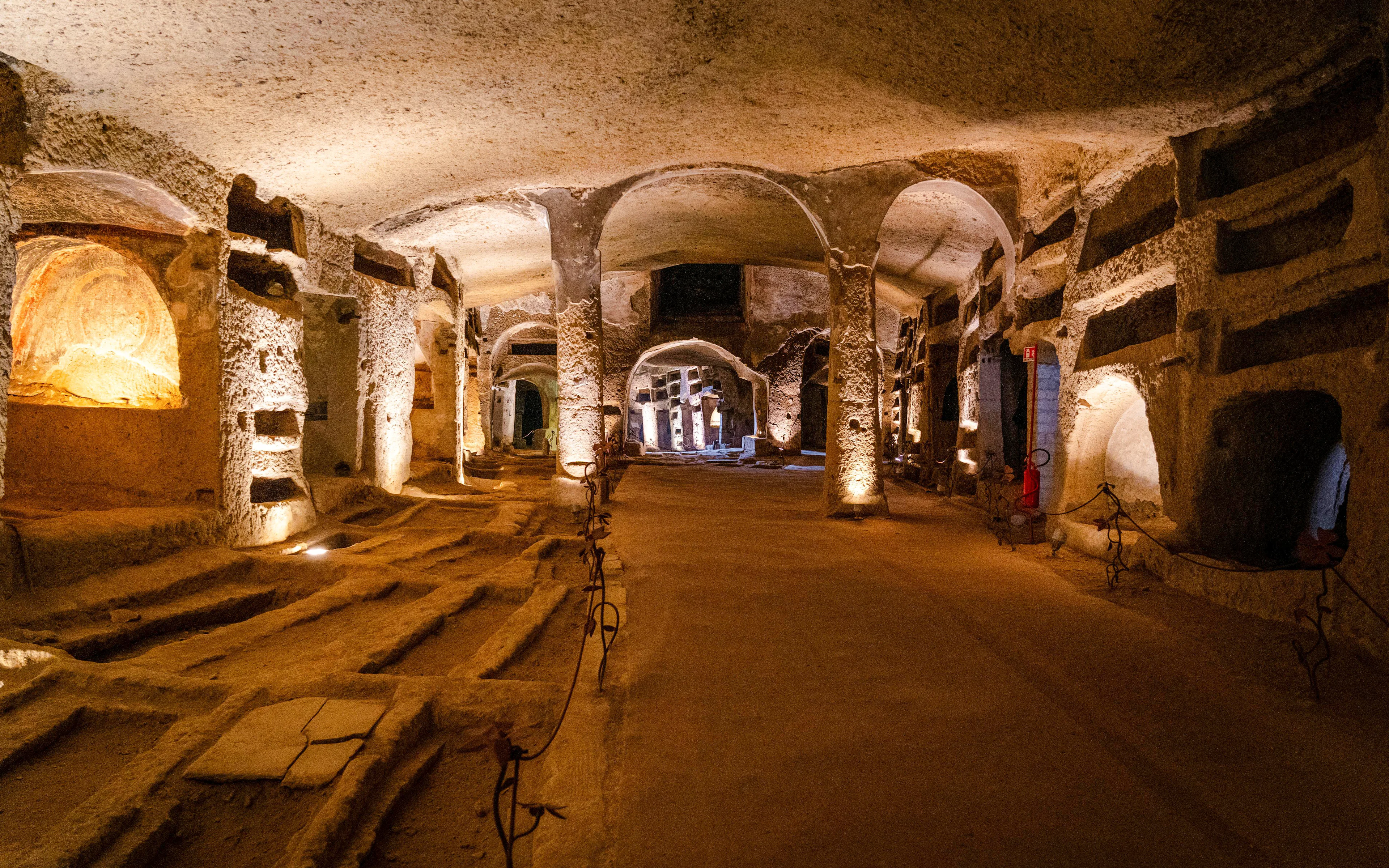 San Gennaro Upper Catacomb Galleries with ancient burial niches and arches.