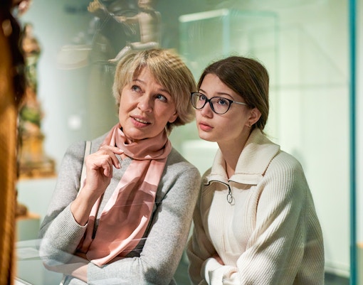 mother and daughter exploring museum artefacts