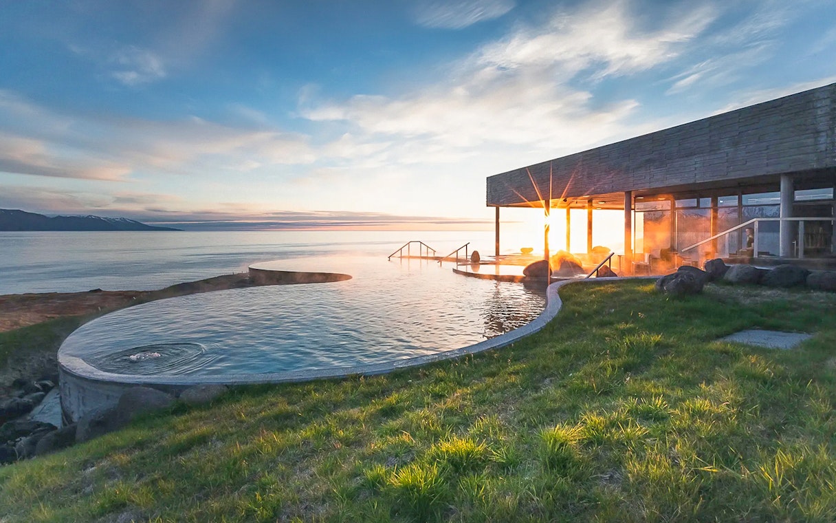 Geosea Geothermal Baths overlooking the ocean at sunset in Iceland.