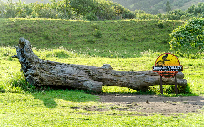 Jurassic Valley sign and fallen log at Kualoa Ranch, Hawaii.