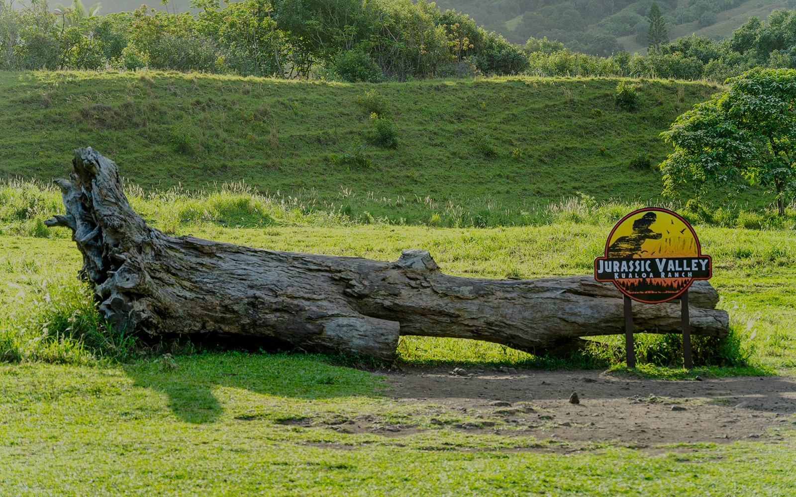 Jurassic Valley sign and fallen log at Kualoa Ranch, Hawaii.