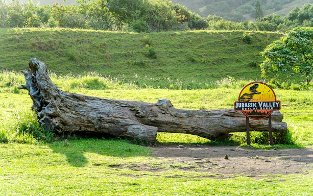Jurassic Valley sign and fallen log at Kualoa Ranch, Hawaii.