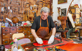 Craftsman working in a leather workshop at Poble Espanyol, Barcelona.