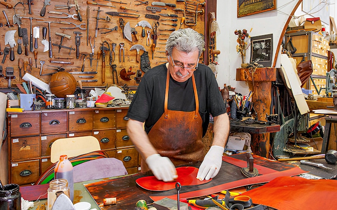 Craftsman working in a leather workshop at Poble Espanyol, Barcelona.