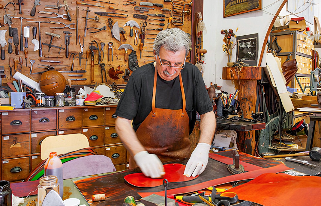 A leather craftsman working inside Poble Espanyol