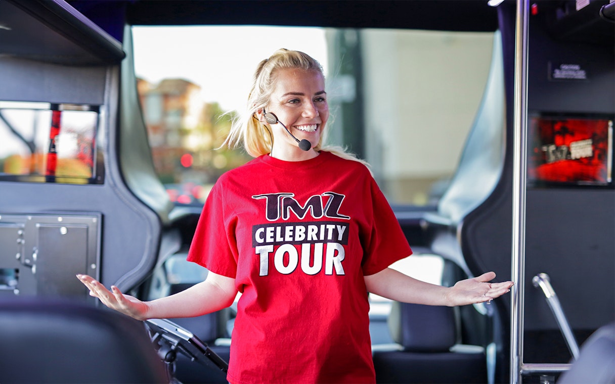 Tour guide on TMZ Hollywood Tour bus with microphone.