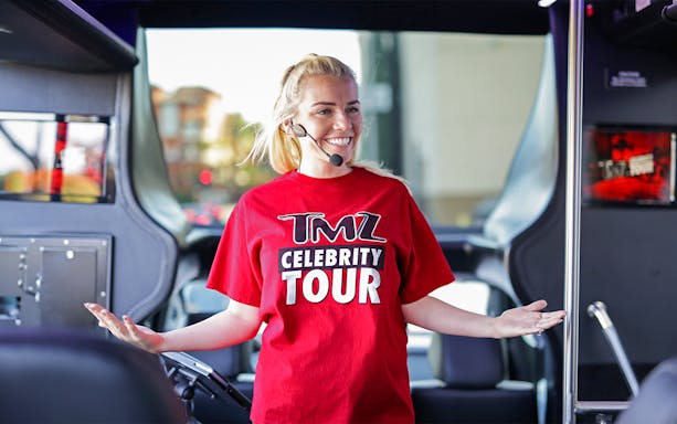 Tour guide on TMZ Hollywood Tour bus with microphone.