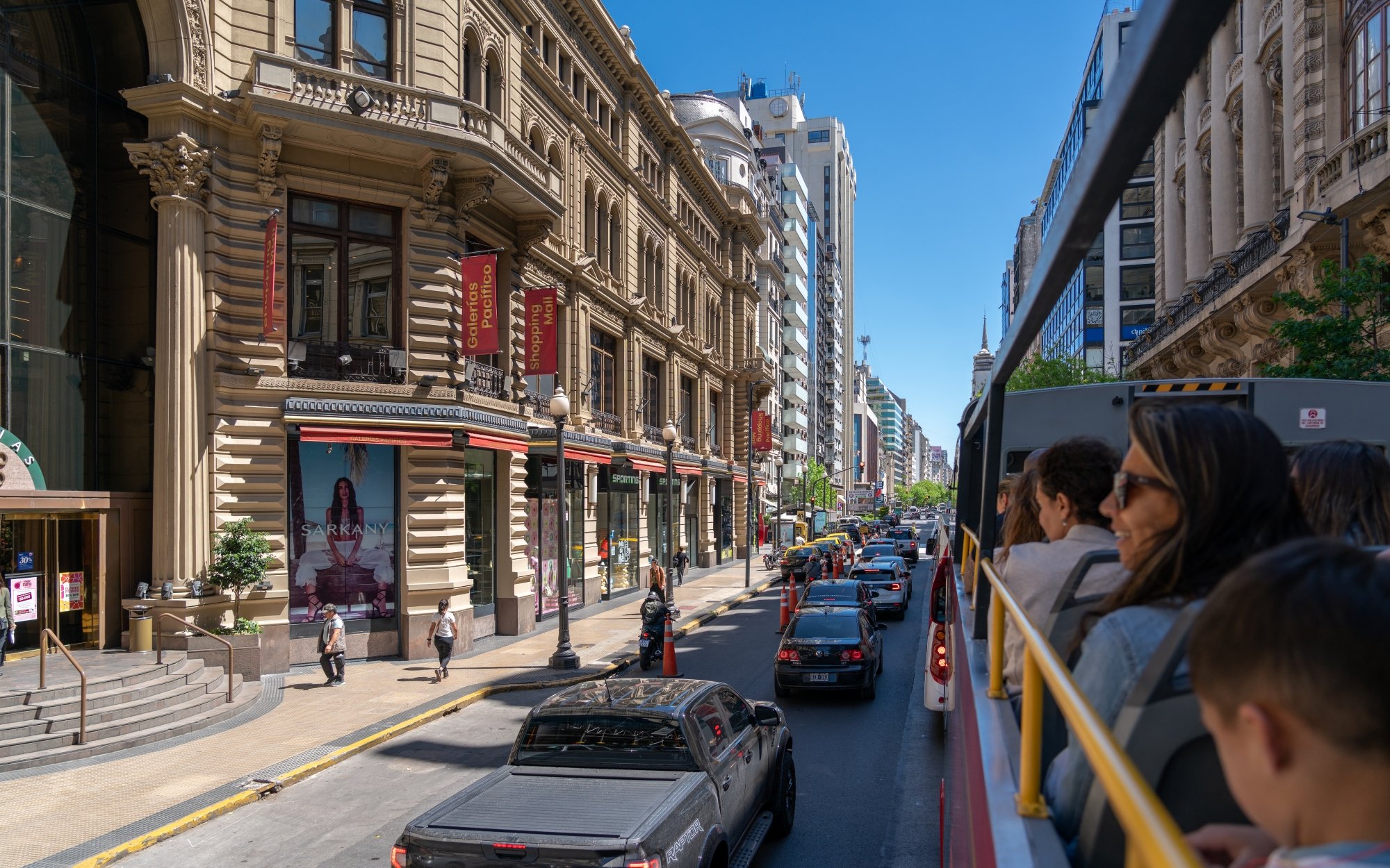 Tourists on Buenos Aires Hop-on Hop-off Bus viewing Esplendor by Wyndham hotel.