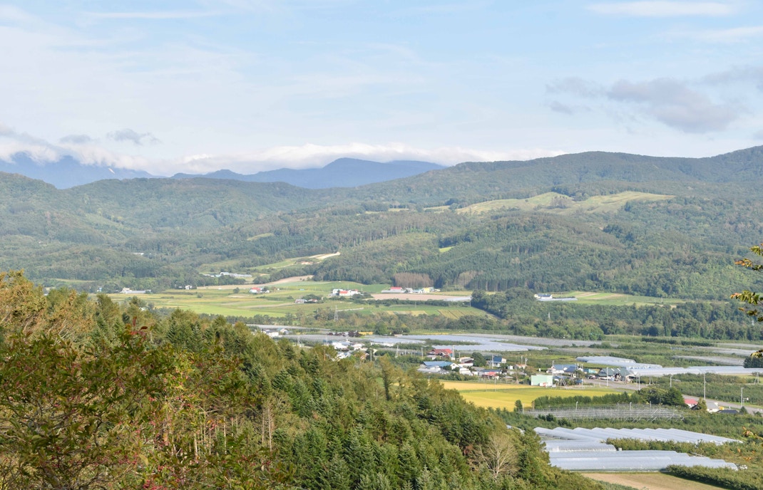 Toya Bungkah Village hot springs with tourists enjoying geothermal pools and scenic mountain views in Bali, Indonesia.