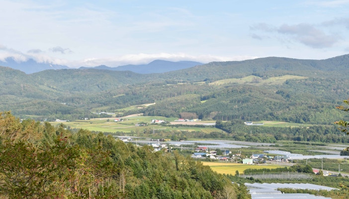 Toya Bungkah Village hot springs with tourists enjoying geothermal pools and scenic mountain views in Bali, Indonesia.