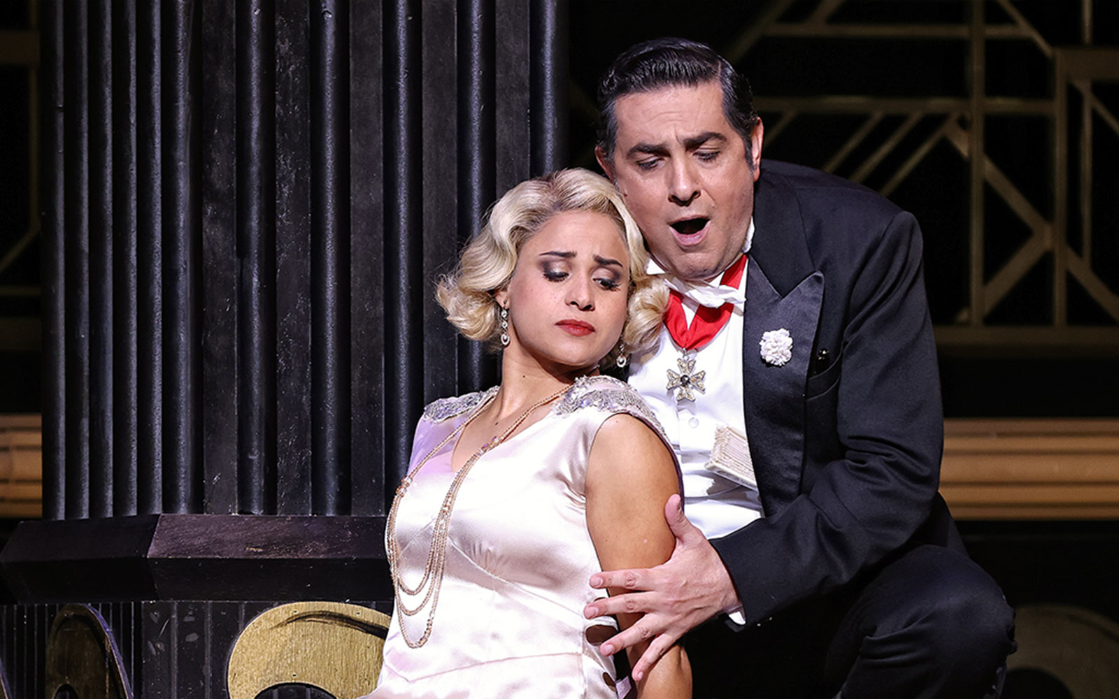 Theatrical scene from The Merry Widow in Sydney with two performers in elegant attire.