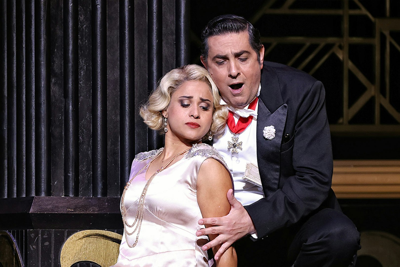 Theatrical scene from The Merry Widow in Sydney with two performers in elegant attire.