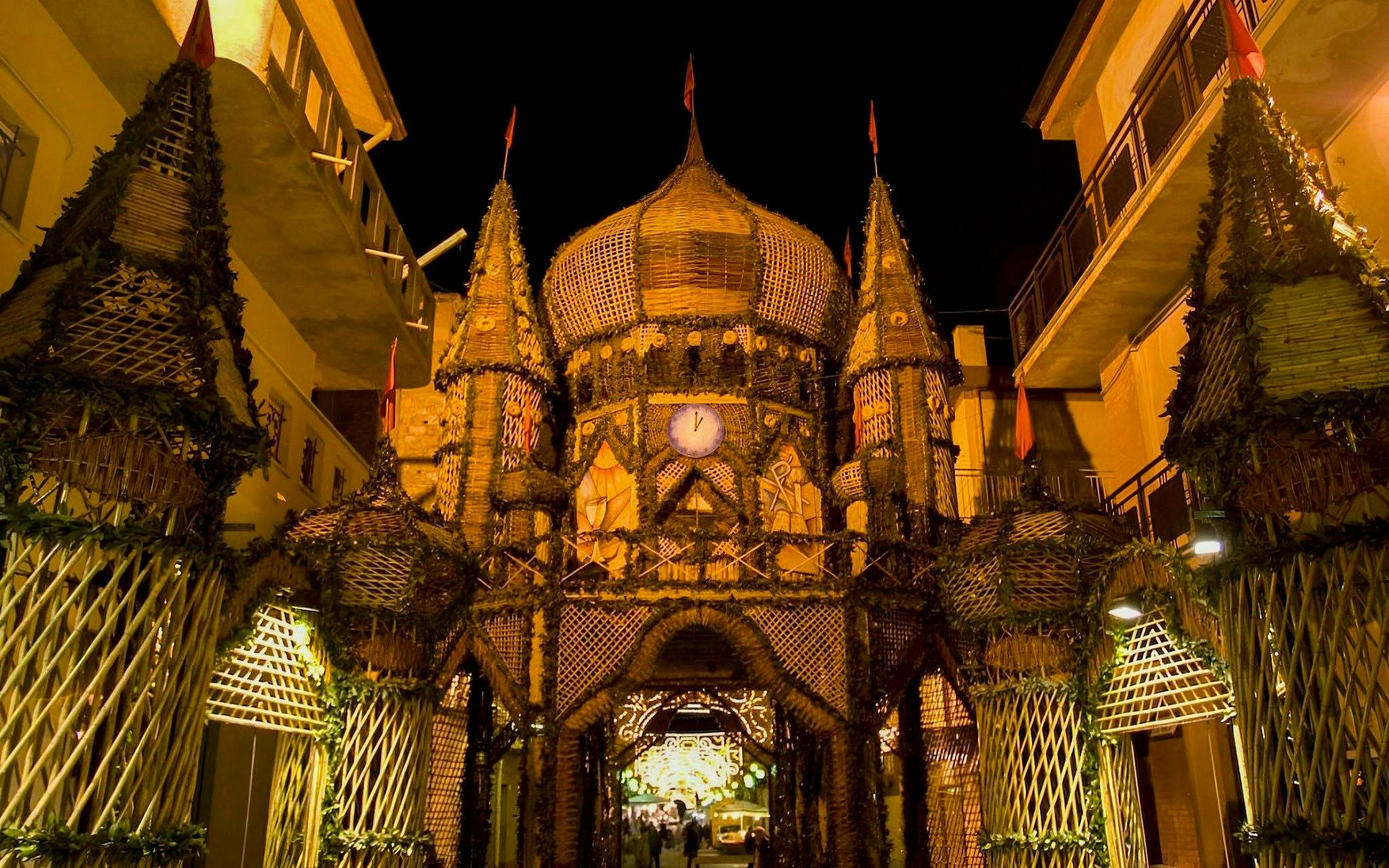 Archi di Pasqua festival structure illuminated at night in San Biagio Platani, Sicily.