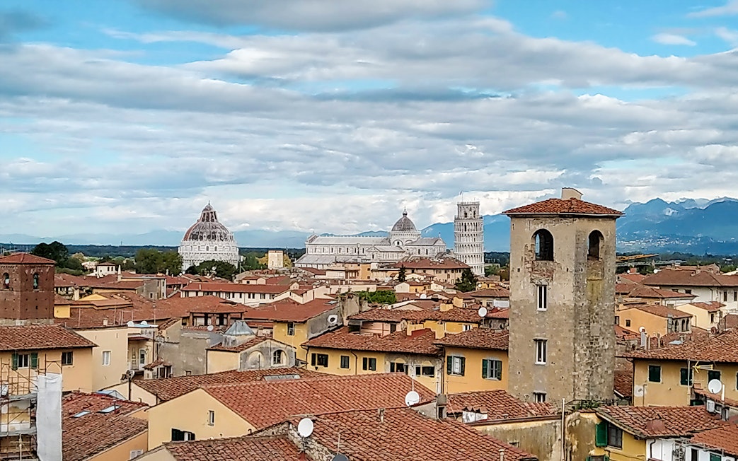 Pisa cityscape with the Leaning Tower and Cathedral in the background.