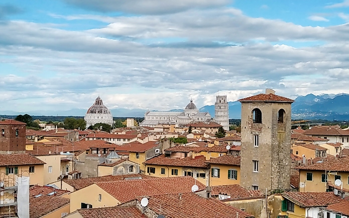 Pisa cityscape with the Leaning Tower and Cathedral in the background.