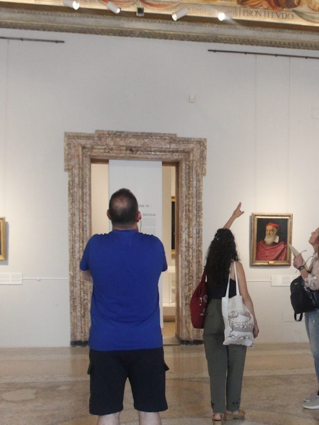 Visitors observing artwork during a guided tour inside Palazzo Barberini, Rome.
