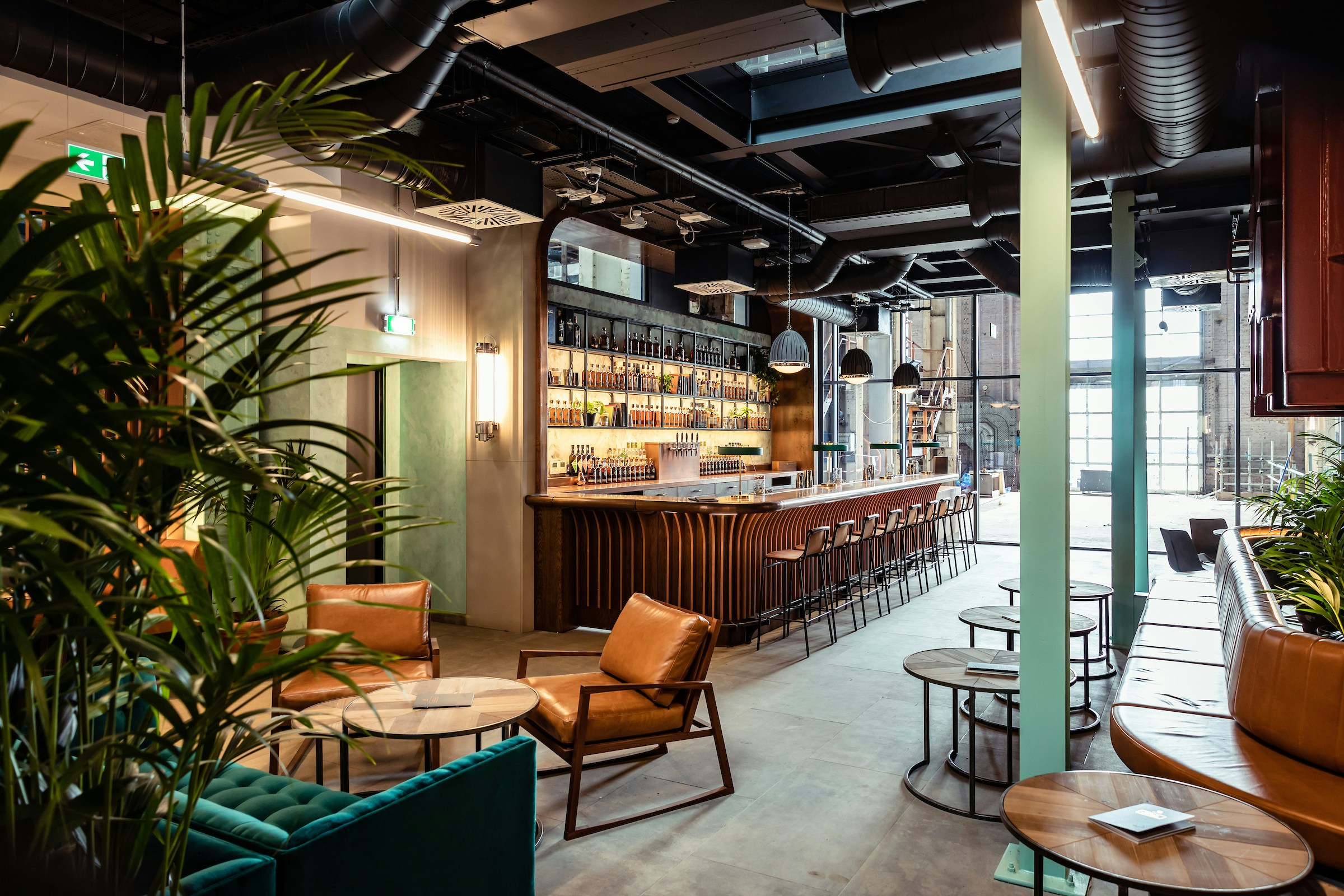 Roe & Co Distillery bar interior with seating and whiskey display.
