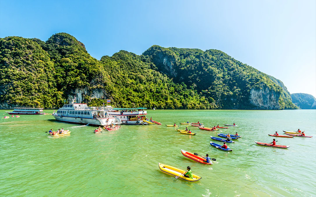 Luxury charter boat with kayakers in Phang Nga Bay, Phuket.