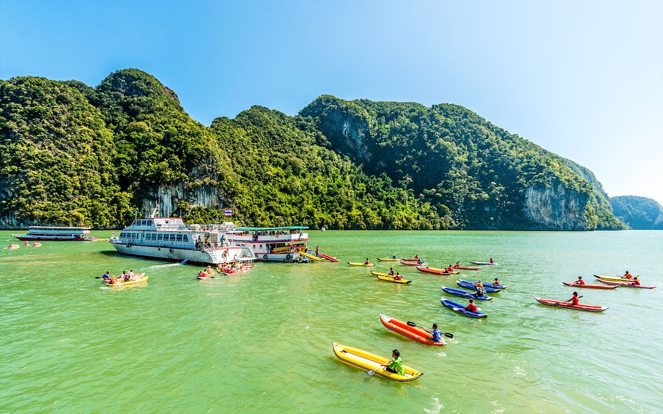 Luxury charter boat with kayakers in Phang Nga Bay, Phuket.