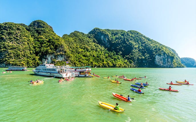 Luxury charter boat with kayakers in Phang Nga Bay, Phuket.