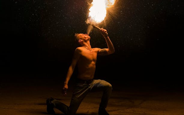 Fire performer at Night Splash event, SplashMania Waterpark.