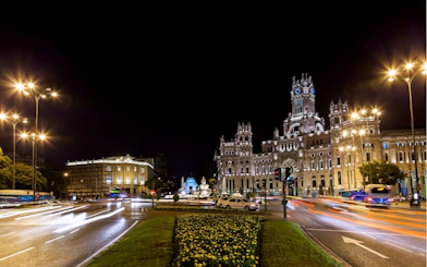 Cibeles Palace illuminated at night in Madrid, part of the Ghosts of Madrid city exploration game.
