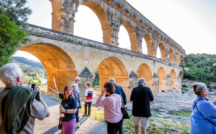 Tour group exploring Pont du Gard aqueduct on Provence Full Day Tour from Aix-en-Provence.