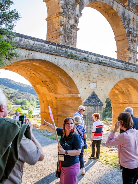 Tour group exploring Pont du Gard aqueduct on Provence Full Day Tour from Aix-en-Provence.