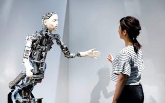 Robot interacting with visitor at Miraikan's permanent exhibition in Tokyo.