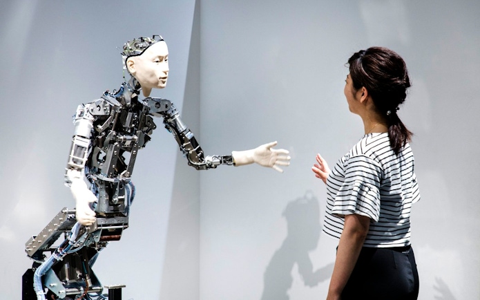 Robot interacting with visitor at Miraikan's permanent exhibition in Tokyo.