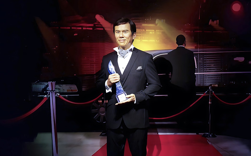 Wax figure holding an award at Madame Tussauds Singapore.
