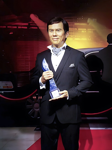 Wax figure holding an award at Madame Tussauds Singapore.