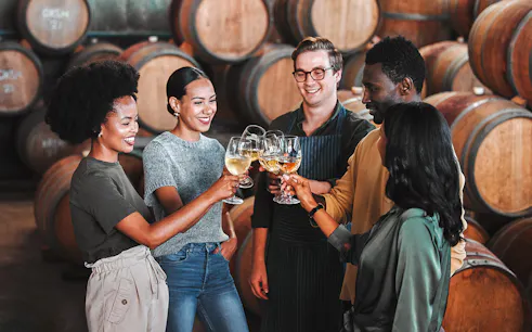 Visitors enjoying a wine tasting at Fonseca port wine cellar.