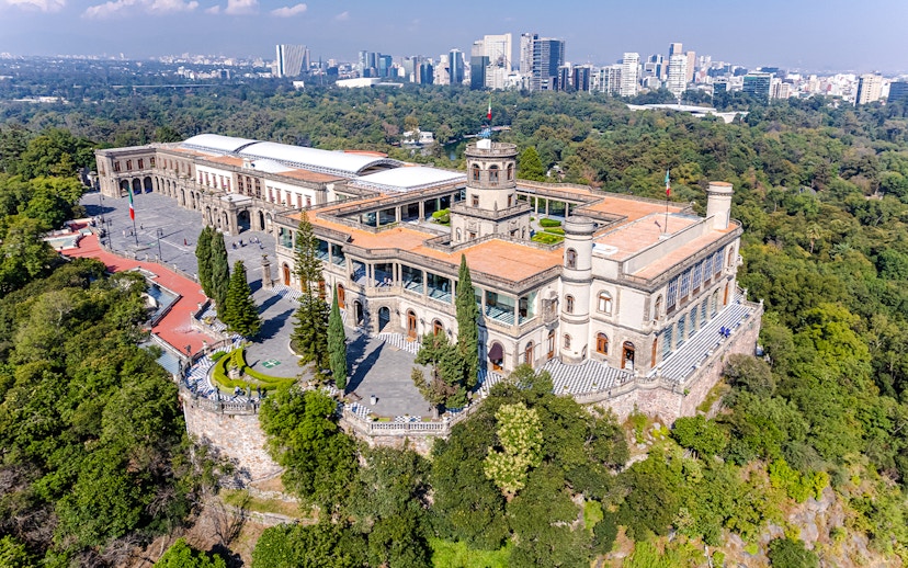 Chapultepec Castle in Mexico City surrounded by lush gardens and historic architecture.