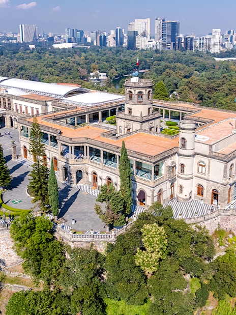 Chapultepec Castle in Mexico City surrounded by lush gardens and historic architecture.
