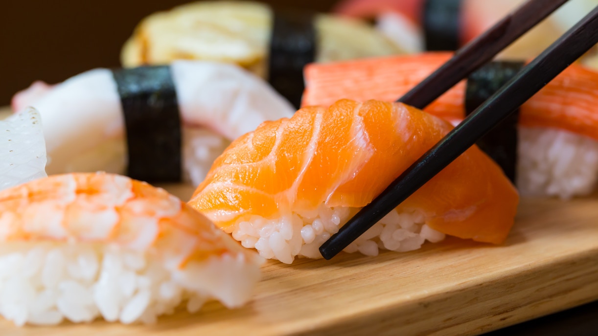 Assorted sushi set with nigiri and rolls on a wooden platter, Tokyo, Japan.