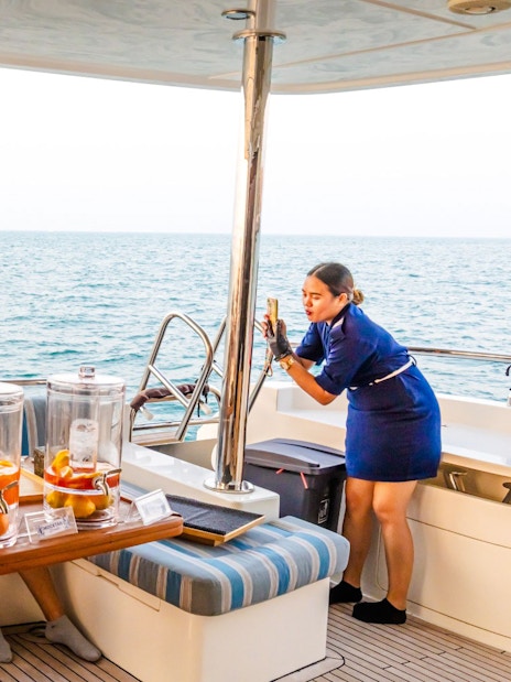 Guide photographing family on yacht cruise, Dubai.