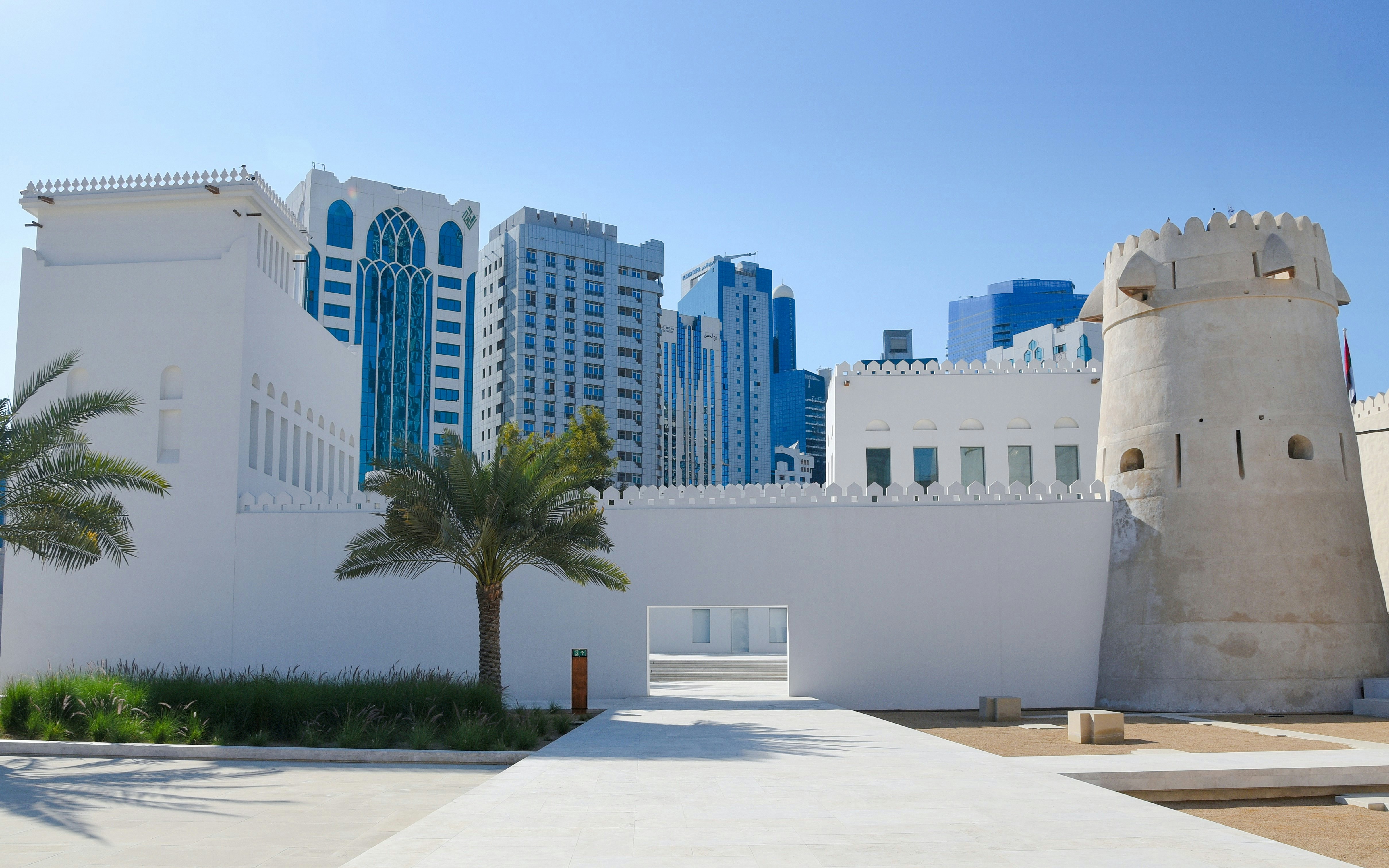 White Qasr Al Hosn with Abu Dhabi skyscrapers in the background.