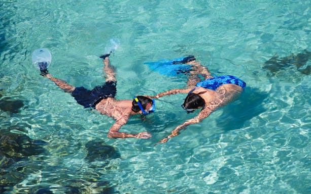 Snorkelers exploring clear waters during Kemer to Phaselis Bay boat trip.