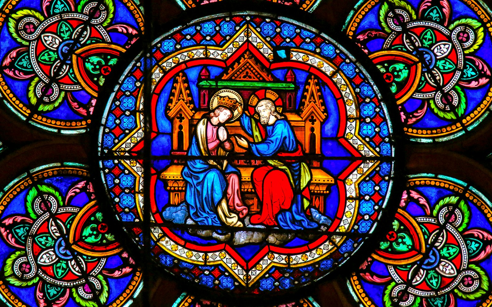 Notre-Dame Cathedral stained glass with tourists using audio guides in Paris.