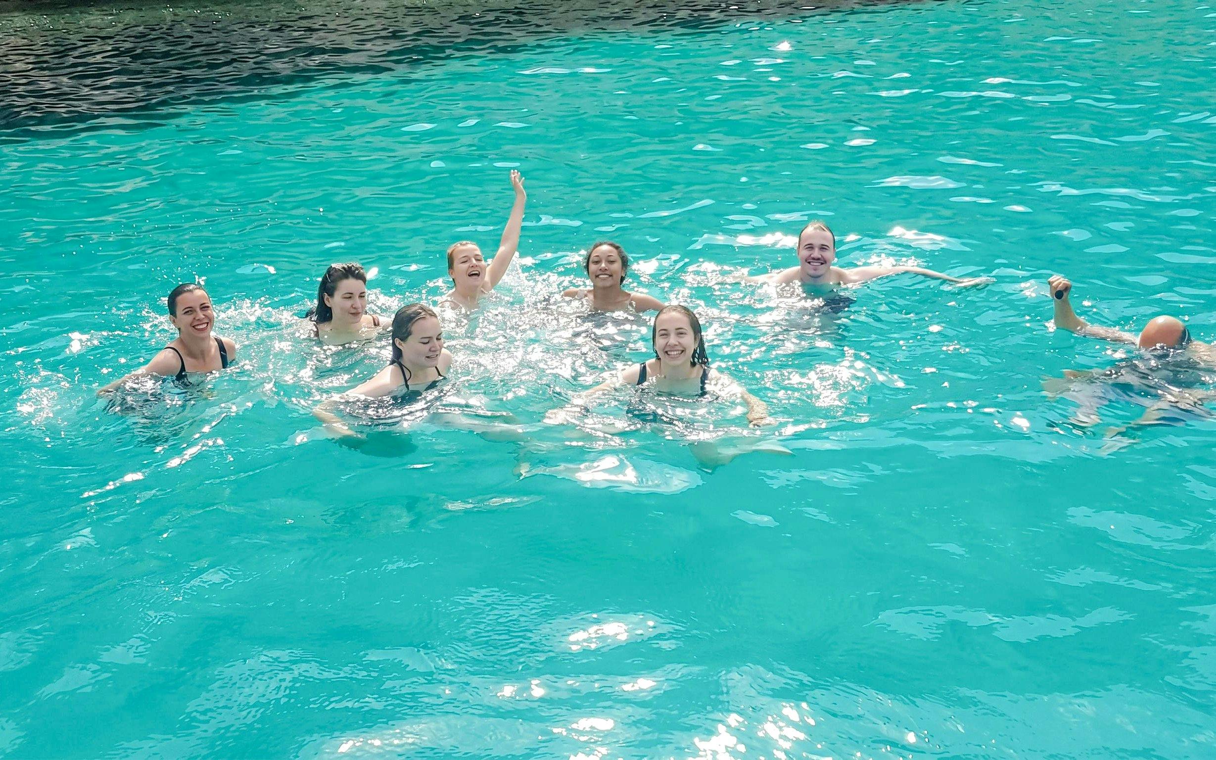Group swimming in turquoise waters near Frioul Archipelago.