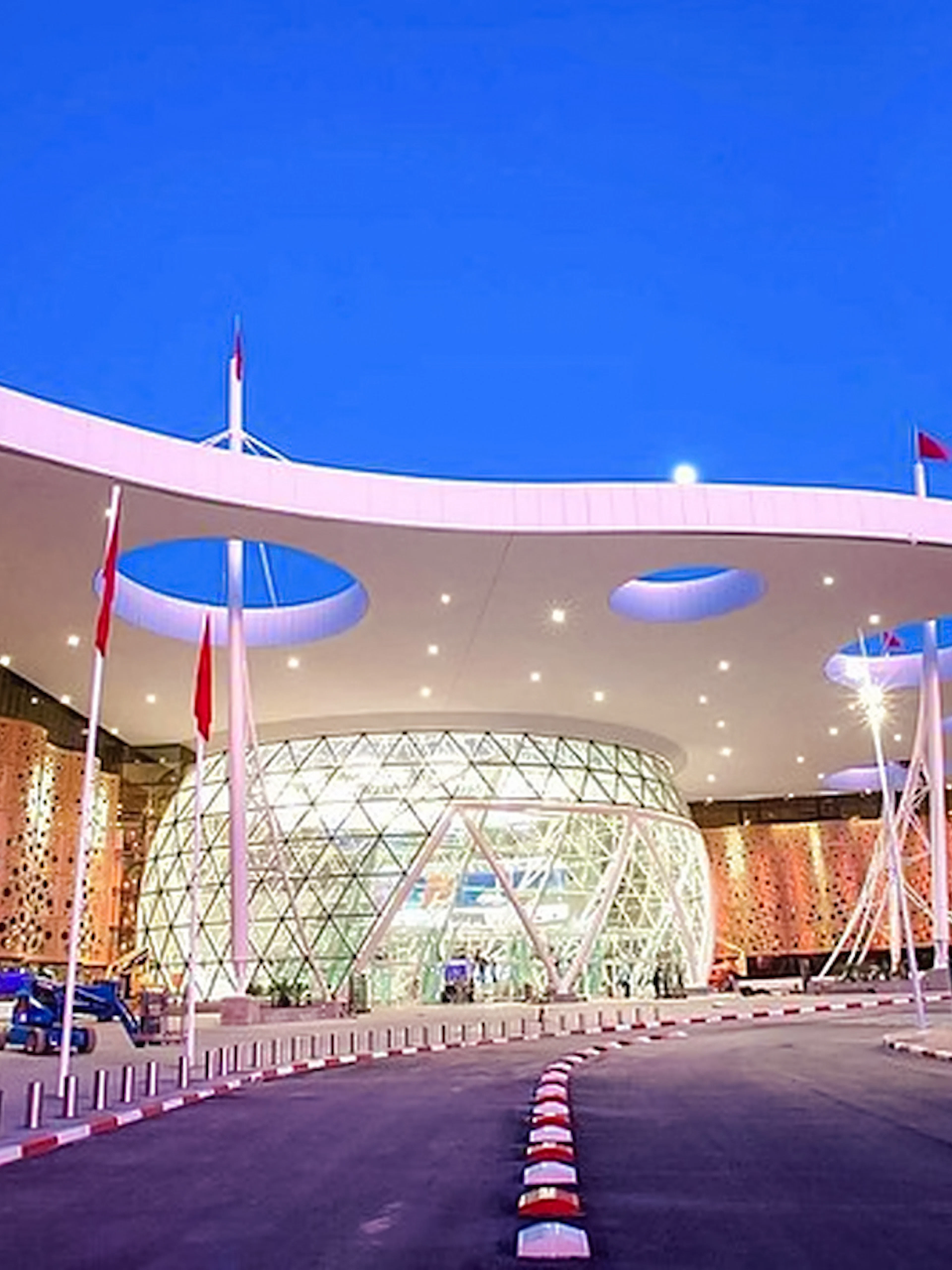 Marrakech Menara Airport entrance at dusk with modern architecture.