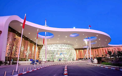Marrakech Menara Airport entrance at dusk with modern architecture.