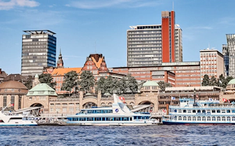 Hamburg Port with boats and city skyline in the background.