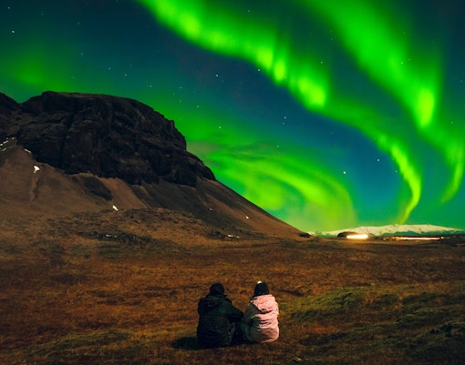 Reindeer sledding under the northern lights in Tromsø, Norway.