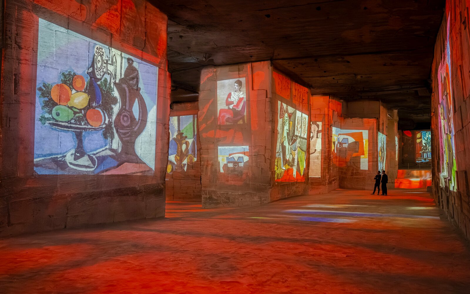 Picasso artworks projected on stone walls at Carrières des Lumières exhibit.