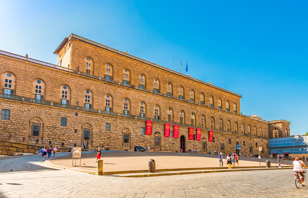 Palazzo Pitti facade in Florence with tourists using skip-the-line entry tickets and audio guides.