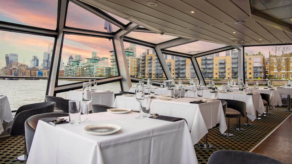 Dining area with river view on a cruise ship in London.
