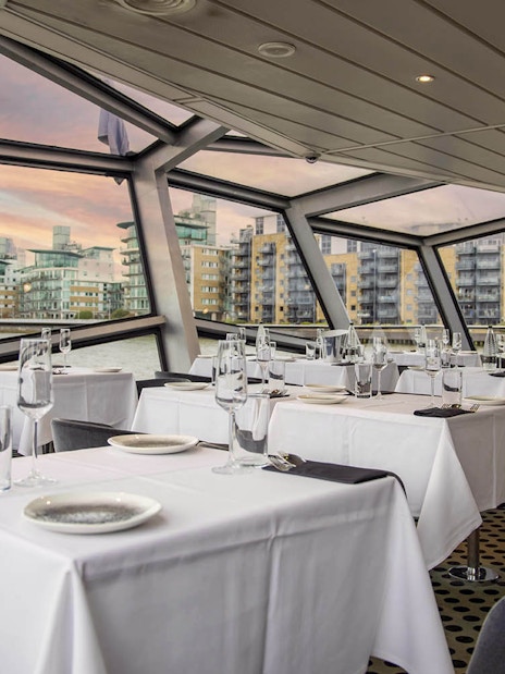 Dining area with river view on a cruise ship in London.