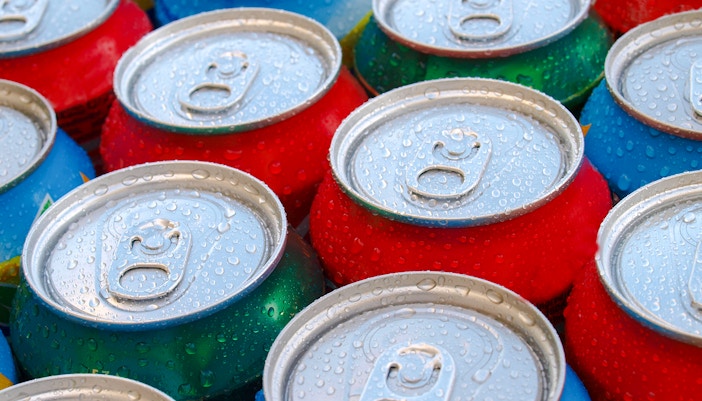 Dhow cruise on Dubai Marina with soft drink cans on table.